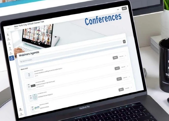 EasyVirtualFair conference area with a webinar agenda displayed on a laptop